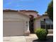 Close up of the front exterior showing stucco walls, terracotta tile roof and a well maintained desert landscape at 6376 W Adobe Dr, Glendale, AZ 85308