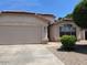 Close up of the front exterior showing stucco walls, terracotta tile roof and a well maintained desert landscape at 6376 W Adobe Dr, Glendale, AZ 85308