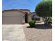 Single-story home with a two-car garage, desert landscaping, and a terracotta tile roof at 6376 W Adobe Dr, Glendale, AZ 85308