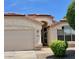 Inviting home exterior featuring a well-maintained front yard and attached garage at 6376 W Adobe Dr, Glendale, AZ 85308