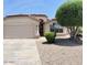 Single-story home with a well-maintained front yard and a two-car garage at 6376 W Adobe Dr, Glendale, AZ 85308