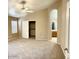 Spacious main bedroom with neutral carpeting, ceiling fan, and ensuite bath access at 6376 W Adobe Dr, Glendale, AZ 85308