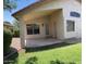 Covered patio with ceiling fan overlooks lush backyard at 6376 W Adobe Dr, Glendale, AZ 85308