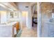 Bathroom with tile floors, shower, and view into an adjacent bedroom at 6415 W Escuda Rd, Glendale, AZ 85308