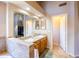Bathroom featuring double sinks, large mirror, and tile flooring at 6415 W Escuda Rd, Glendale, AZ 85308