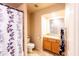Bathroom featuring shower-tub, toilet, and vanity with decorative curtain at 6415 W Escuda Rd, Glendale, AZ 85308