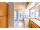 Bright bathroom with a glass shower, soaking tub, and door to the outside at 6415 W Escuda Rd, Glendale, AZ 85308