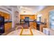 Bright eat-in kitchen features black appliances, wood cabinets and tile floors at 6415 W Escuda Rd, Glendale, AZ 85308