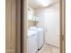 Clean laundry room with modern washer and dryer, shelving, and tile flooring at 6415 W Escuda Rd, Glendale, AZ 85308