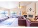 Features a ceiling fan, fireplace, tile flooring, and natural light at 6415 W Escuda Rd, Glendale, AZ 85308