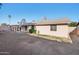 View of the backyard with a covered patio, mature trees, and brick exterior at 9641 N 36Th Dr, Phoenix, AZ 85051