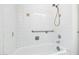 The tiled shower features a hand-held shower head, grab bars, and vintage detailing at 9641 N 36Th Dr, Phoenix, AZ 85051
