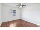 Well-lit bedroom with laminate flooring, ceiling fan, and a large window offering natural light at 9641 N 36Th Dr, Phoenix, AZ 85051