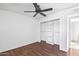 A bedroom featuring wood-look flooring, a ceiling fan, and a closet with sliding doors at 9641 N 36Th Dr, Phoenix, AZ 85051