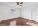 Bright bedroom featuring hardwood floors, ceiling fan, and closet at 9641 N 36Th Dr, Phoenix, AZ 85051