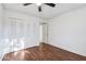 Comfortable bedroom featuring laminate flooring, a ceiling fan and a spacious closet at 9641 N 36Th Dr, Phoenix, AZ 85051