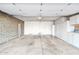 A spacious garage with built-in storage, a brick accent wall, and two entry doors at 9641 N 36Th Dr, Phoenix, AZ 85051