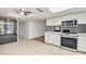 The kitchen features white cabinets, countertops, stainless appliances, and tile flooring at 9641 N 36Th Dr, Phoenix, AZ 85051