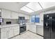 Updated kitchen featuring white cabinets, stainless steel appliances, and modern lighting at 9641 N 36Th Dr, Phoenix, AZ 85051