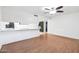 This open-concept space features a breakfast bar, light walls, and dark wood vinyl flooring at 9641 N 36Th Dr, Phoenix, AZ 85051