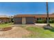 Back exterior with covered patio, manicured yard and desert plants at 10022 W Mountain View Rd, Sun City, AZ 85351