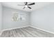 Bedroom with modern flooring, a ceiling fan, light gray walls, and a bright window at 10022 W Mountain View Rd, Sun City, AZ 85351