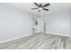 Bright bedroom features light gray walls, gray wood-look floors, and natural light at 10022 W Mountain View Rd, Sun City, AZ 85351