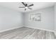 A light-filled bedroom with a ceiling fan and updated flooring at 10022 W Mountain View Rd, Sun City, AZ 85351