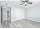 A bright bedroom featuring a ceiling fan, closet and updated flooring at 10022 W Mountain View Rd, Sun City, AZ 85351