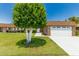 Landscaped front yard highlighting the home's curb appeal with lush greenery and a manicured lawn at 10022 W Mountain View Rd, Sun City, AZ 85351