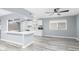 Stylish kitchen with bright white cabinets, stainless appliances, white countertops, and modern laminate flooring at 10022 W Mountain View Rd, Sun City, AZ 85351