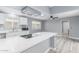 Modern kitchen showcases white cabinets, white countertops, stainless appliances, and recessed lighting at 10022 W Mountain View Rd, Sun City, AZ 85351