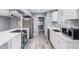 Updated kitchen with stainless steel appliances, white cabinets, and a view to the living area at 10022 W Mountain View Rd, Sun City, AZ 85351