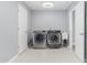 Laundry room with appliances, sink and tile flooring at 10022 W Mountain View Rd, Sun City, AZ 85351