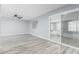 Bright living room with updated flooring, fan, and slider, perfect for modern living at 10022 W Mountain View Rd, Sun City, AZ 85351