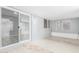 Covered patio featuring large windows, tile floor, and sliding glass door access at 10022 W Mountain View Rd, Sun City, AZ 85351