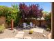 Relaxing backyard oasis with Adirondack chairs, desert landscaping, and privacy wall at 11103 E Blue Sky Dr, Scottsdale, AZ 85262