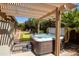 Relaxing backyard with a hot tub, pergola, and a synthetic grass putting green at 11103 E Blue Sky Dr, Scottsdale, AZ 85262