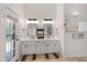 Bright bathroom featuring double sinks, stylish fixtures, and access to the outdoor patio at 11103 E Blue Sky Dr, Scottsdale, AZ 85262
