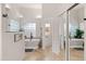 Bright bathroom featuring a soaking tub, glass block window, double sinks and sliding mirror door at 11103 E Blue Sky Dr, Scottsdale, AZ 85262