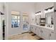 Bright bathroom with double sinks, and a door to the backyard patio at 11103 E Blue Sky Dr, Scottsdale, AZ 85262