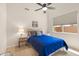 Comfortable bedroom featuring a ceiling fan, neutral walls, and a window with privacy blinds at 11103 E Blue Sky Dr, Scottsdale, AZ 85262