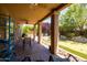 Covered patio features dining and lounge areas and a view of the backyard with putting green at 11103 E Blue Sky Dr, Scottsdale, AZ 85262
