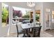 Cozy dining area with a view of the landscaped backyard, perfect for Gathering meals or entertaining guests at 11103 E Blue Sky Dr, Scottsdale, AZ 85262