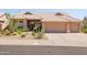 Charming single-story home with desert landscaping, a three-car garage, and a classic tile roof at 11103 E Blue Sky Dr, Scottsdale, AZ 85262