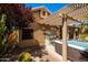 Exterior view with pergola covered hot tub and desert landscaping at 11103 E Blue Sky Dr, Scottsdale, AZ 85262