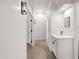 Clean hallway with neutral tones, cabinet, decorative lighting, and wood flooring at 11103 E Blue Sky Dr, Scottsdale, AZ 85262