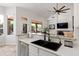 Modern kitchen with granite countertops, stainless steel appliances, and black sink with a view of the backyard at 11103 E Blue Sky Dr, Scottsdale, AZ 85262