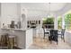 Eat-in kitchen features white cabinetry, stainless steel appliances, and a breakfast bar with stylish seating at 11103 E Blue Sky Dr, Scottsdale, AZ 85262