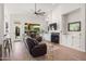 Bright living room featuring a fireplace, built-ins, and a large leather sofa at 11103 E Blue Sky Dr, Scottsdale, AZ 85262